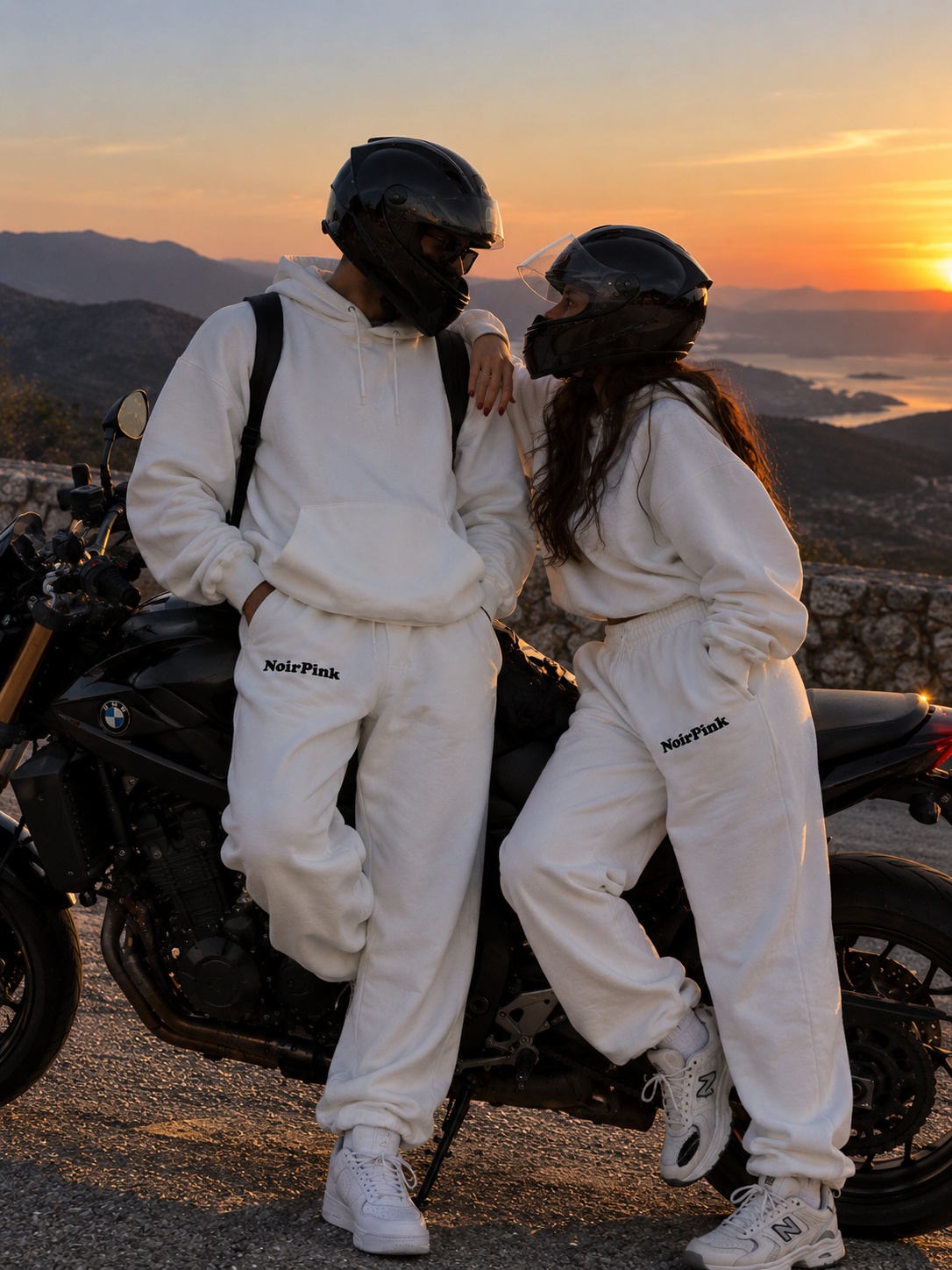 Couple in matching NoirPink Blanc sets at sunset